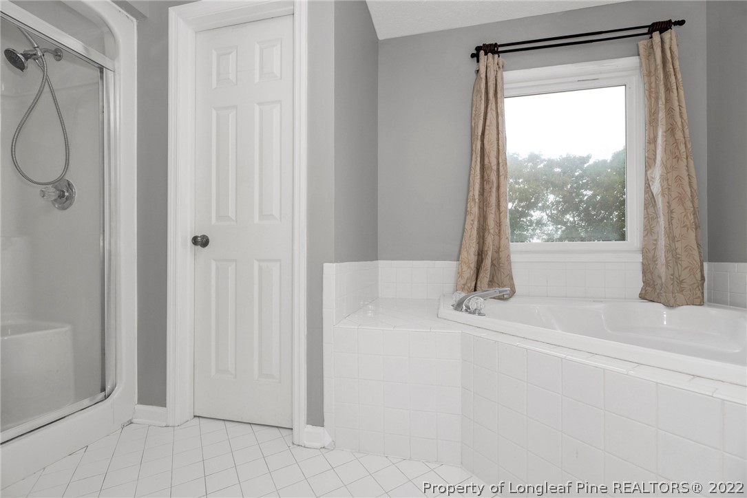 338 Lionshead Road Fayetteville, NC 28311 - Photo 31 of 39 a bathroom with a glass shower door