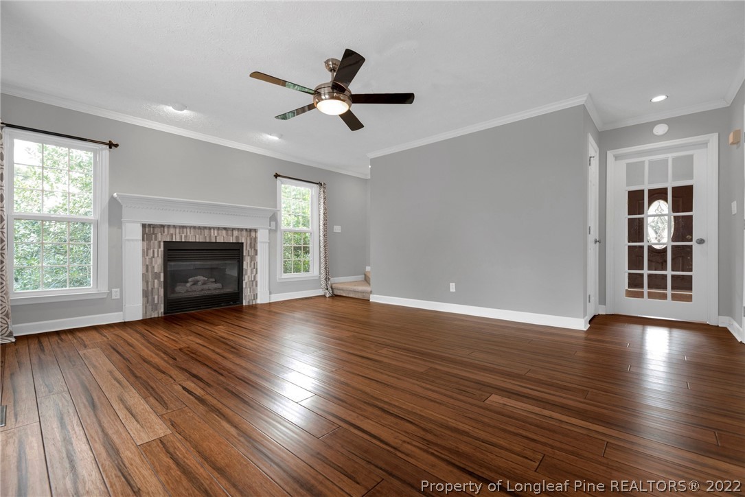 338 Lionshead Road Fayetteville, NC 28311 - Photo 10 of 39 an empty room with wooden floor fireplace and windows