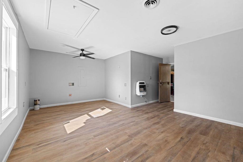 235 Hardeman Street Grand Junction, TN 38039 - Photo 11 of 20 a view of empty room with wooden floor and fan