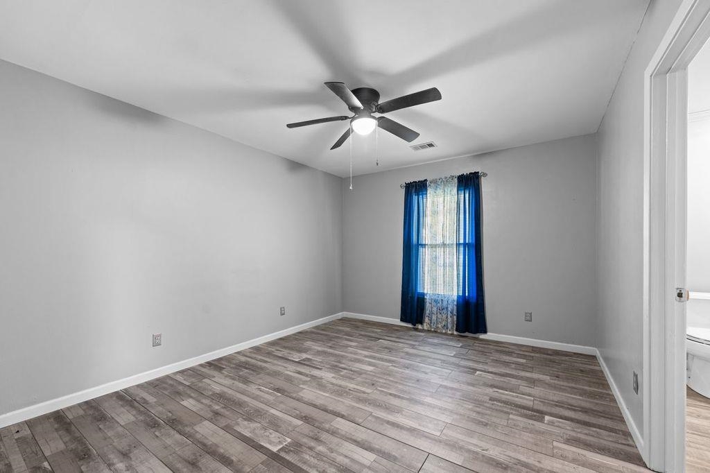 235 Hardeman Street Grand Junction, TN 38039 - Photo 15 of 20 a view of empty room with wooden floor and fan