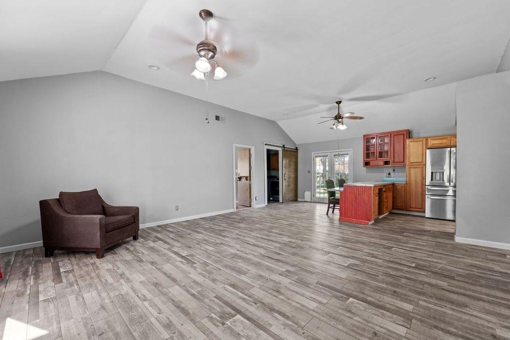 235 Hardeman Street Grand Junction, TN 38039 - Photo 4 of 20 a large room with chandelier fan and wooden floor
