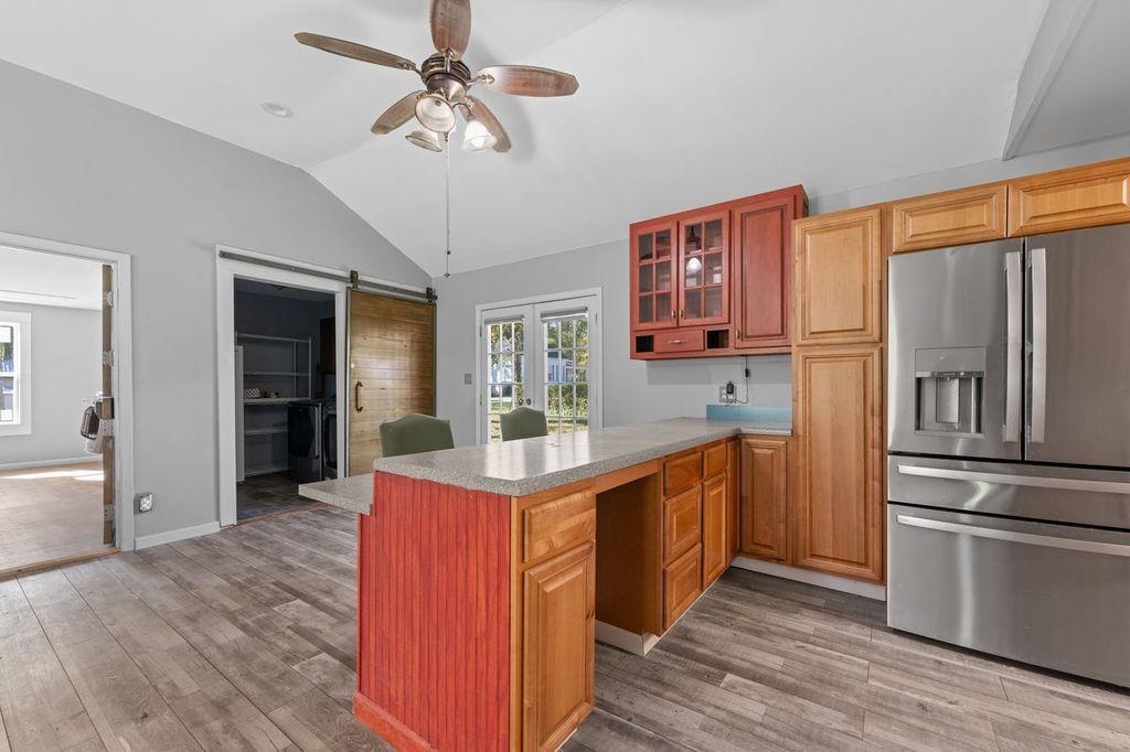 235 Hardeman Street Grand Junction, TN 38039 - Photo 5 of 20 a kitchen with stainless steel appliances granite countertop a refrigerator a stove and a sink with wooden floors