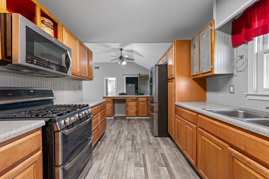 235 Hardeman Street Grand Junction, TN 38039 - Photo 8 of 20 a kitchen with stainless steel appliances granite countertop a stove a sink and a microwave