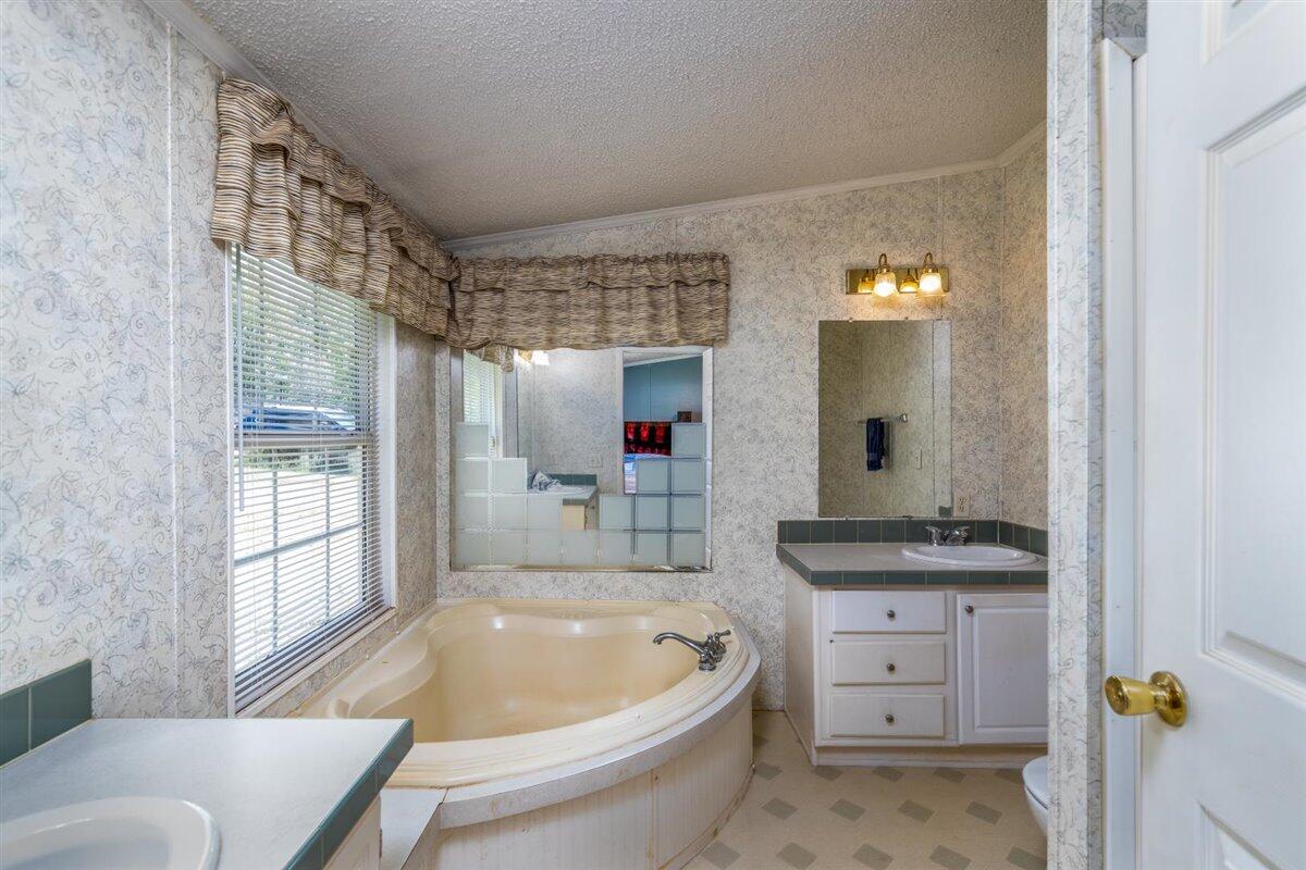 10 Tolley Road Hardy, VA 24101 - Photo 17 of 25 a bathroom with a granite countertop tub sink and mirror