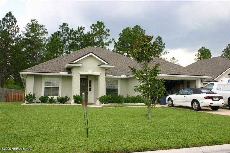 1649 Redstone Court St. Augustine, FL 32092 - Photo 4 of 4 a front view of a house with a garden