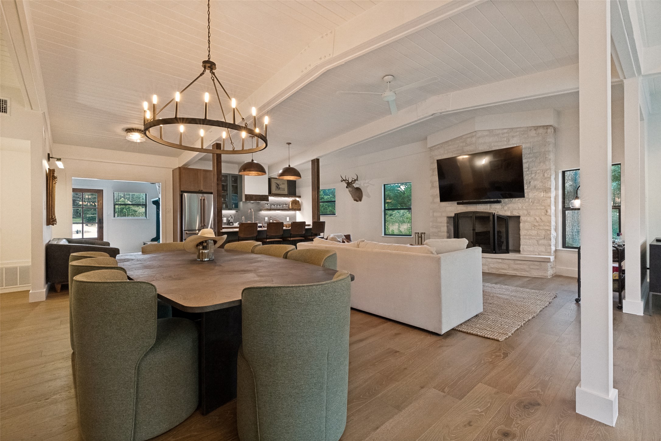 303 Lago Verde Road Austin, TX 78734 - Photo 39 of 39 An open floorplan seamlessly connects a generous dining area to a spacious living room with a stately stone fireplace.