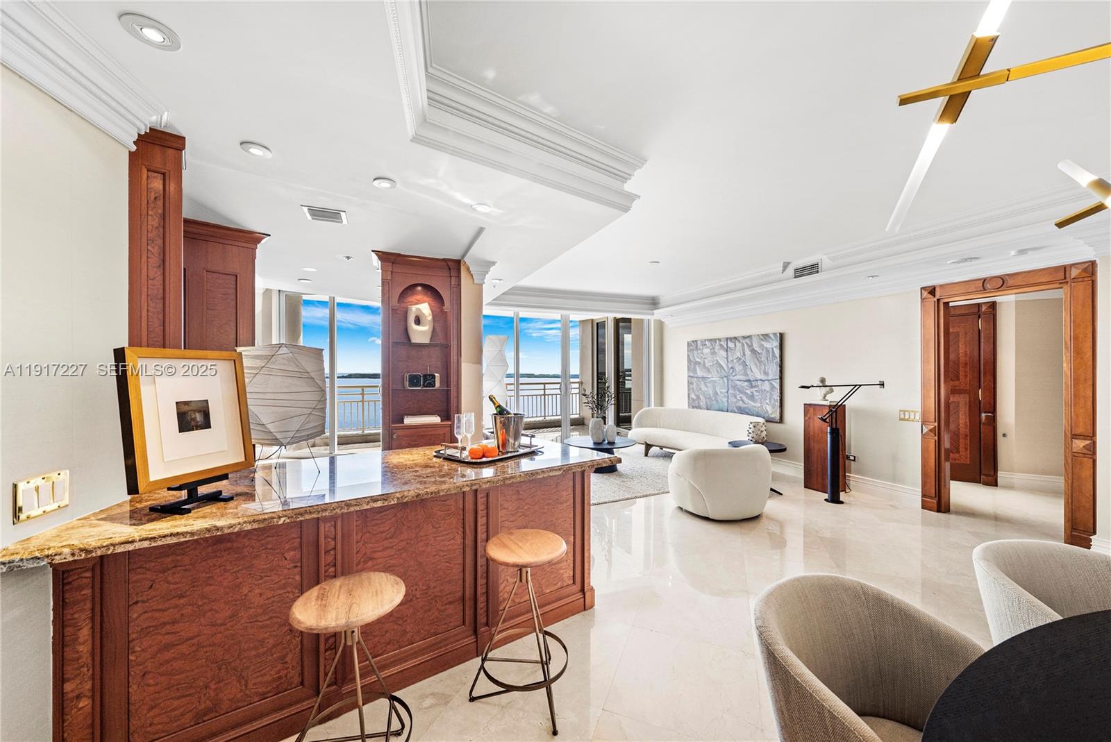 808 Brickell Key Drive, Unit 1802 Miami, FL 33131 - Photo 13 of 43 a living room with furniture a chandelier and a table