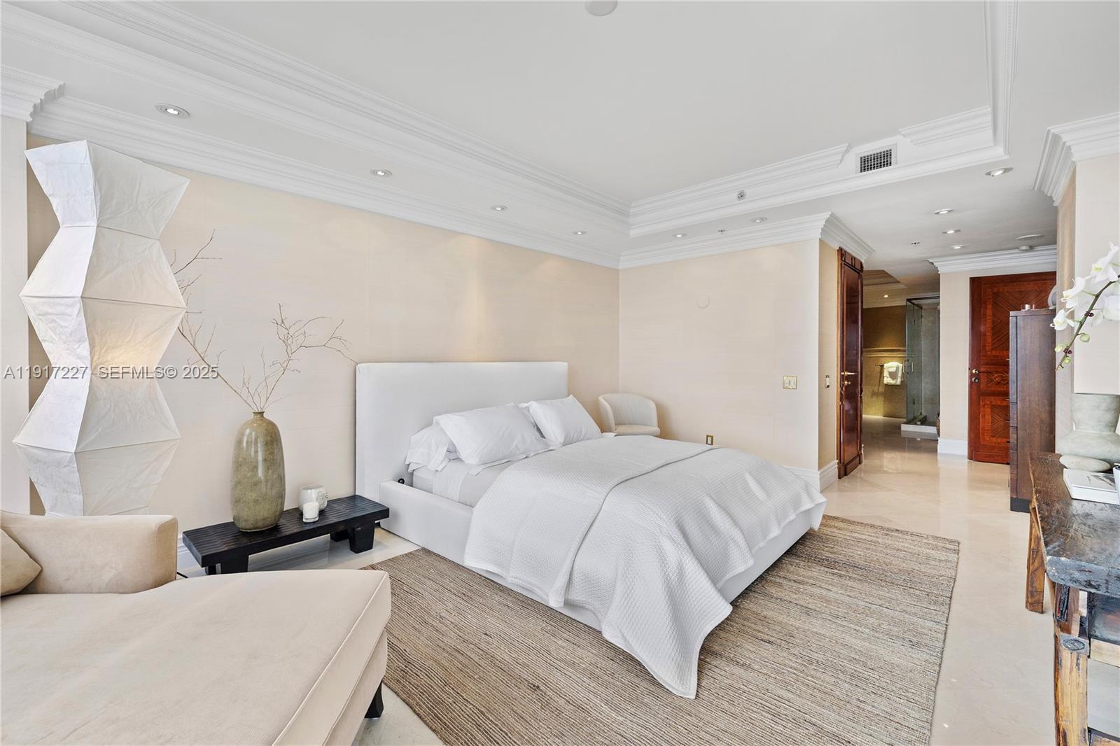 808 Brickell Key Drive, Unit 1802 Miami, FL 33131 - Photo 23 of 43 a bedroom with bed and a couch