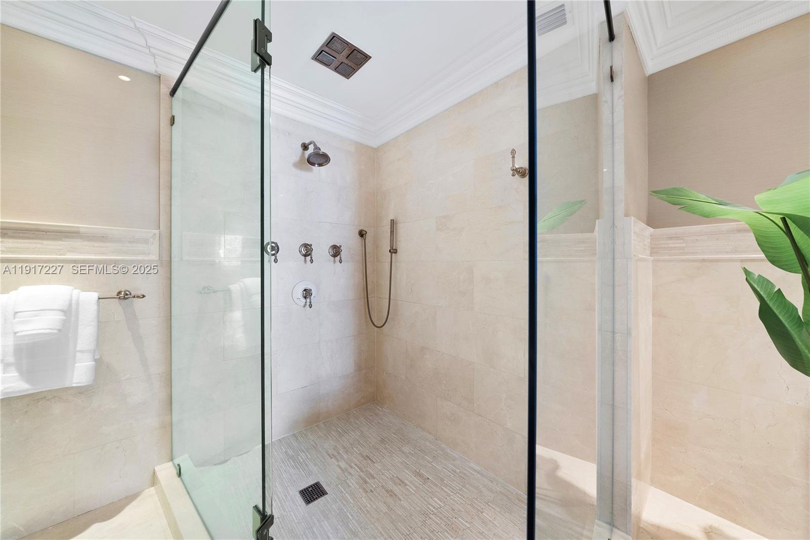 808 Brickell Key Drive, Unit 1802 Miami, FL 33131 - Photo 26 of 43 a bathroom with a glass shower door and a glass door