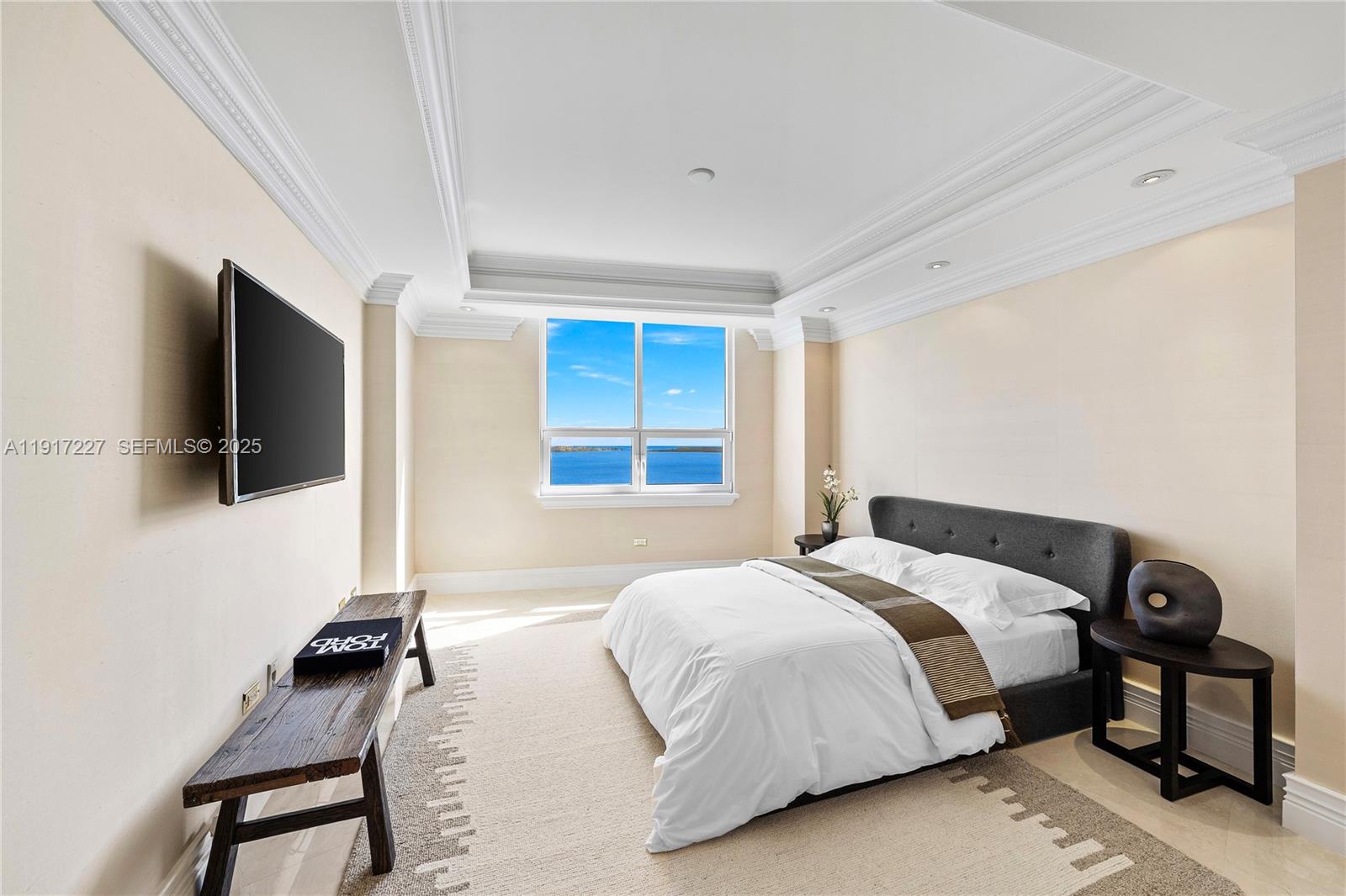 808 Brickell Key Drive, Unit 1802 Miami, FL 33131 - Photo 27 of 43 a bedroom with a bed a tv and wooden floor