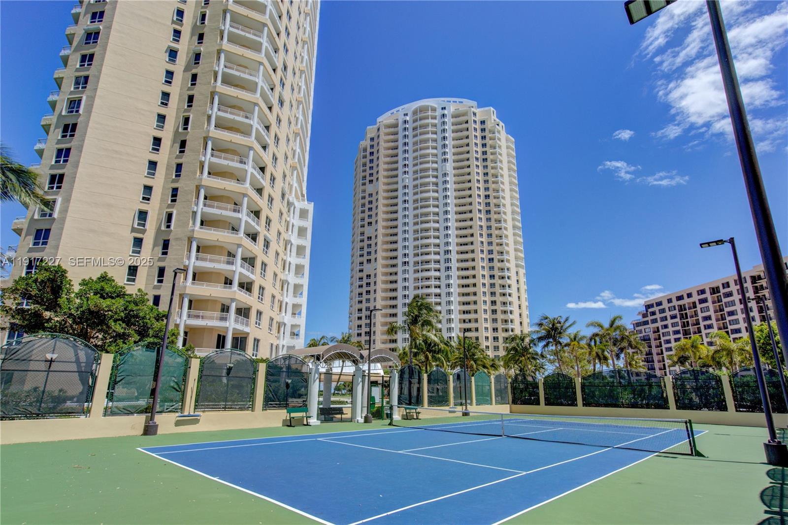 808 Brickell Key Drive, Unit 1802 Miami, FL 33131 - Photo 43 of 43 a view of a tall building next to a yard