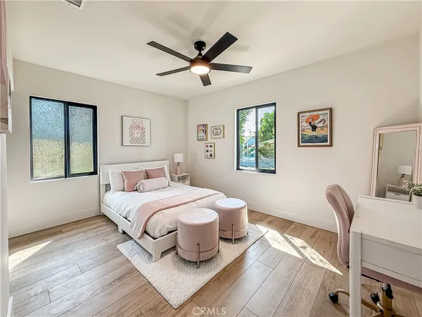 a bedroom with a bed and wooden floor
