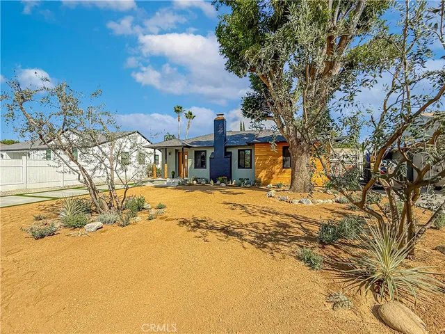 a front view of a house with a yard covered with snow