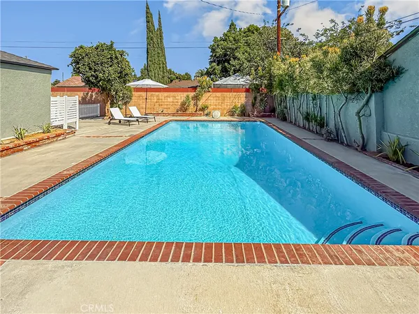 a view of a backyard with a swimming pool