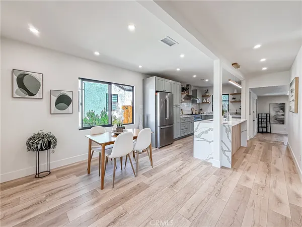 a dining room with furniture and a floor to ceiling window