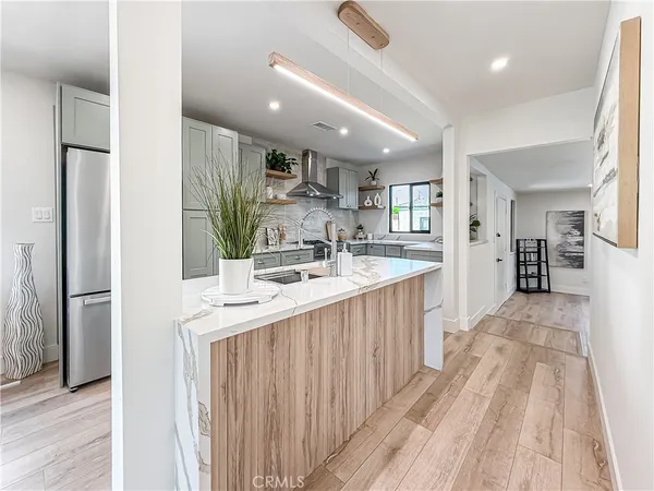 a kitchen with kitchen island a sink appliances and cabinets