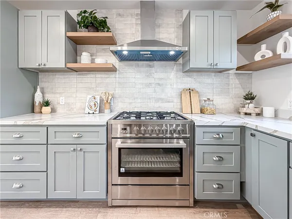 a stove top oven sitting inside of a kitchen