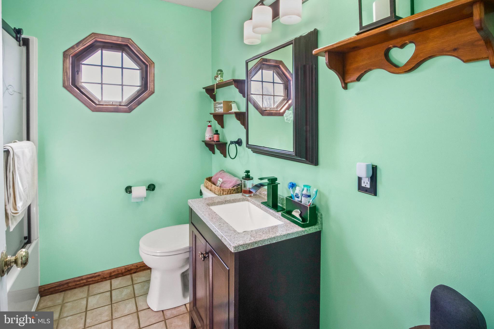 10 South Hook Road Pennsville, NJ 08070 - Photo 18 of 40 a bathroom with a sink mirror vanity and toilet