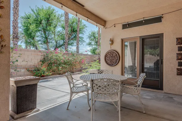 a view of a chairs and table in a patio