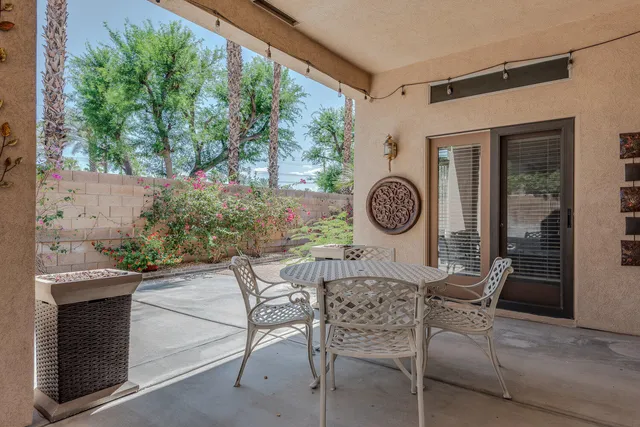 a view of a chairs and table in a patio