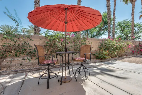 a patio with a patio table and chairs under an umbrella