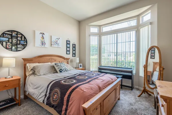 a bedroom with a bed and a window