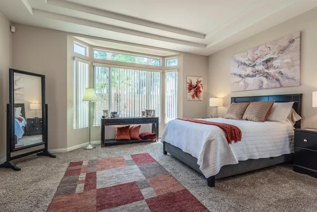 a bed sitting in a bedroom next to a window