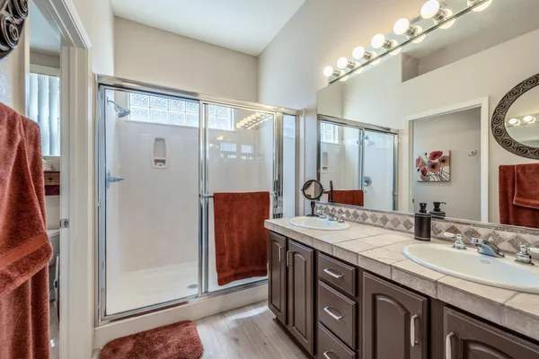 a bathroom with a double vanity sink and a mirror