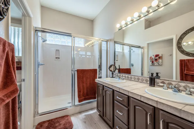 a bathroom with a double vanity sink and a mirror