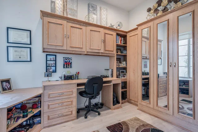 a view of a workspace with furniture and a window