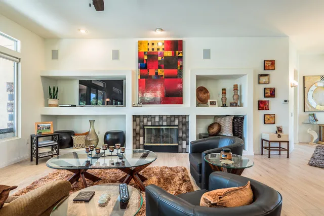 a living room with fireplace furniture and decor