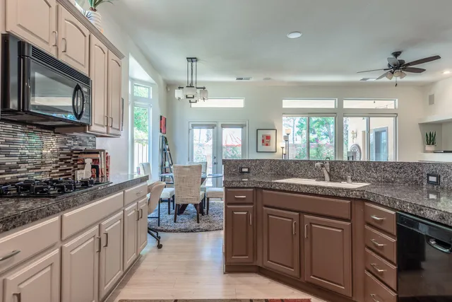 a kitchen with a sink stove and cabinets