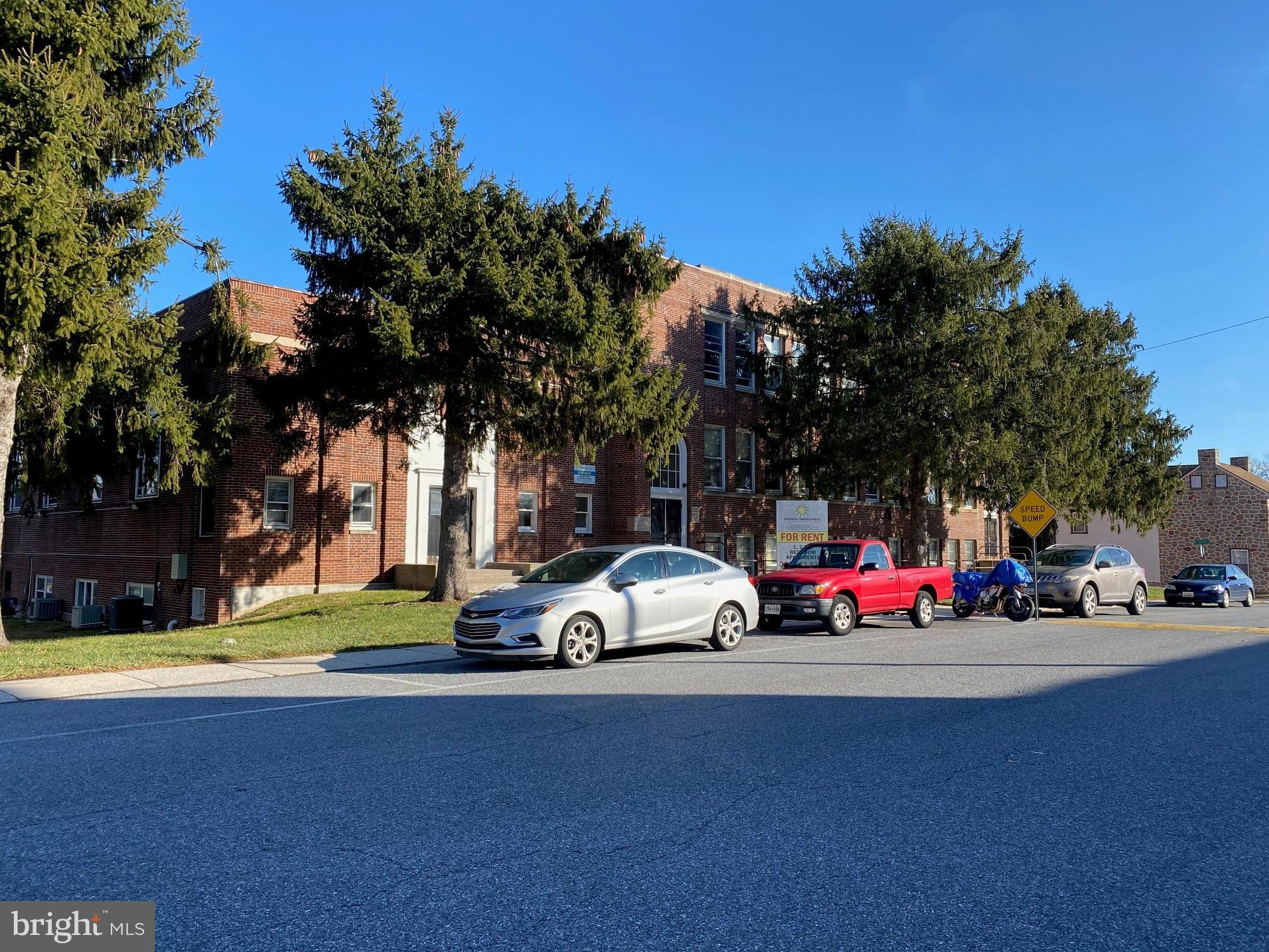 a view of street with parked cars