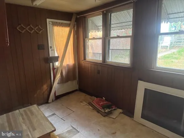 a view of an empty room with a fireplace and a window