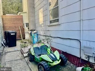 a view of backyard with outdoor seating and plants