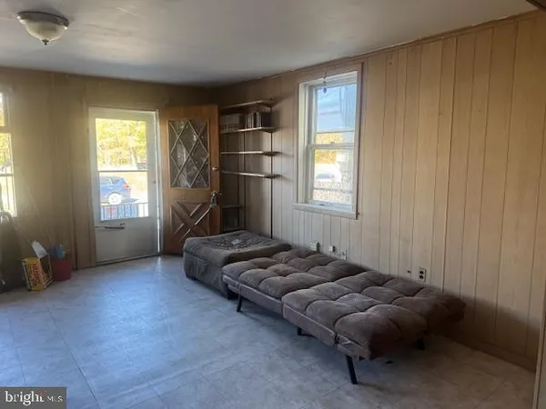 a bedroom with bed couch and window
