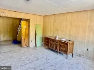 a view of a room with furniture and a window