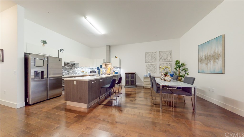 a kitchen with a refrigerator and a dining table