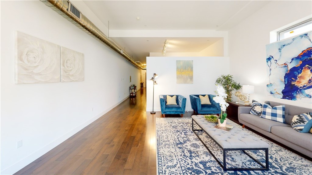 433 Pine Avenue, Unit 308 Long Beach, CA 90802 - Photo 22 of 24 a living room with furniture and wooden floor