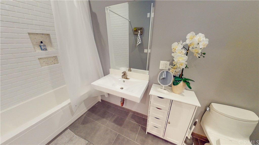 433 Pine Avenue, Unit 308 Long Beach, CA 90802 - Photo 8 of 24 a bathroom with a sink a toilet and shower
