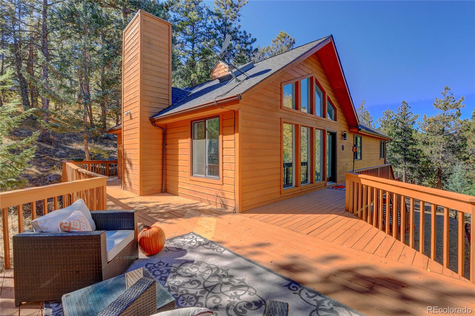 a backyard of a house with deck and outdoor seating