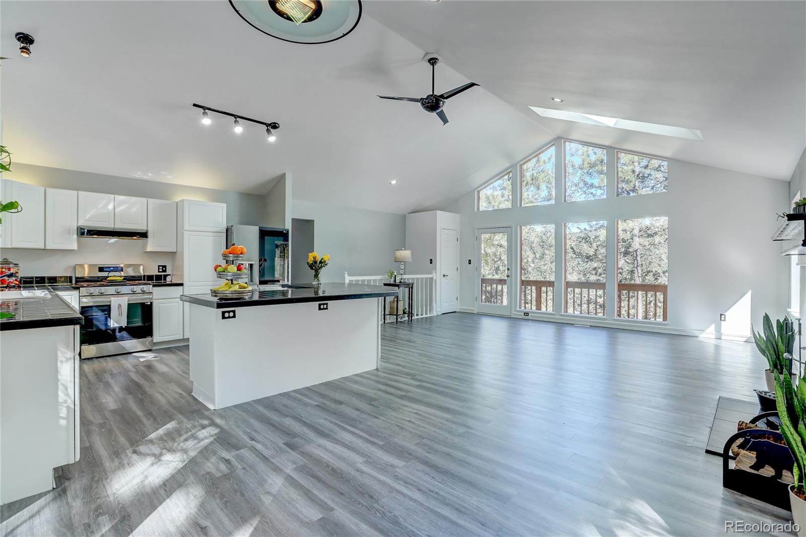 1469 Roland Drive Bailey, CO 80421 - Photo 11 of 39 a view of a kitchen with kitchen island wooden floor and stainless steel appliances