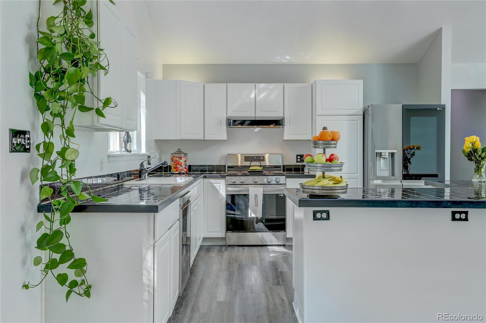 1469 Roland Drive Bailey, CO 80421 - Photo 12 of 39 a kitchen with kitchen island granite countertop a sink a stove and cabinets