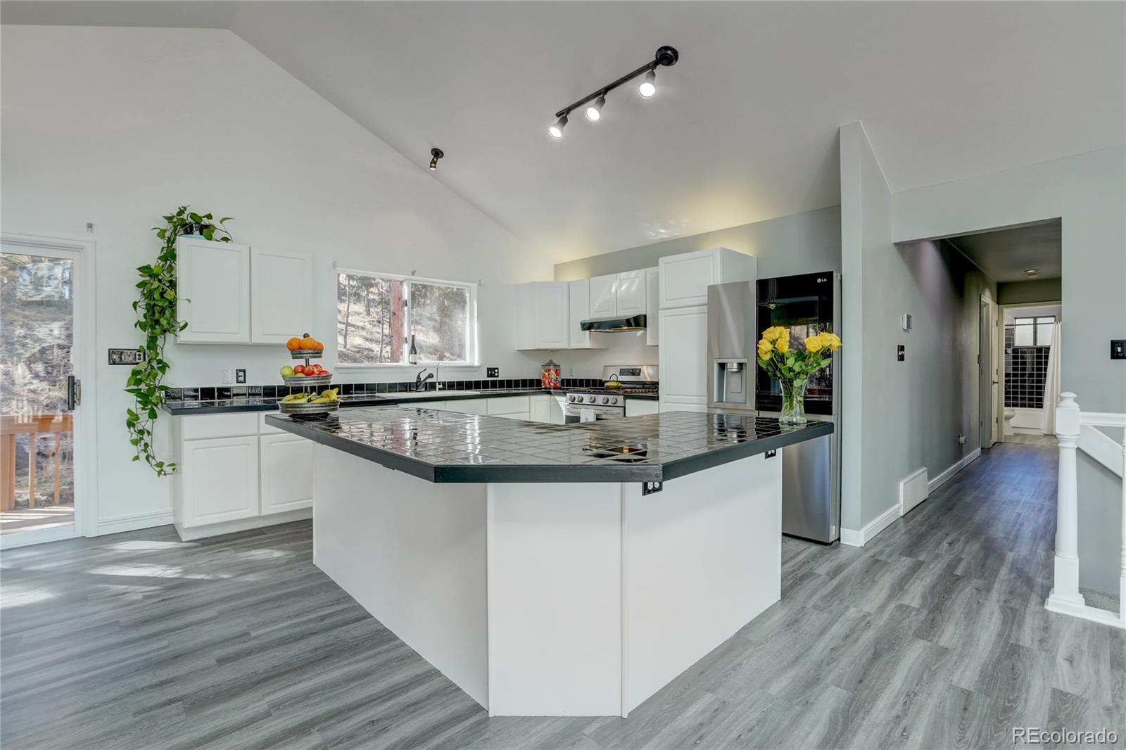 1469 Roland Drive Bailey, CO 80421 - Photo 13 of 39 a kitchen with granite countertop a sink and cabinets