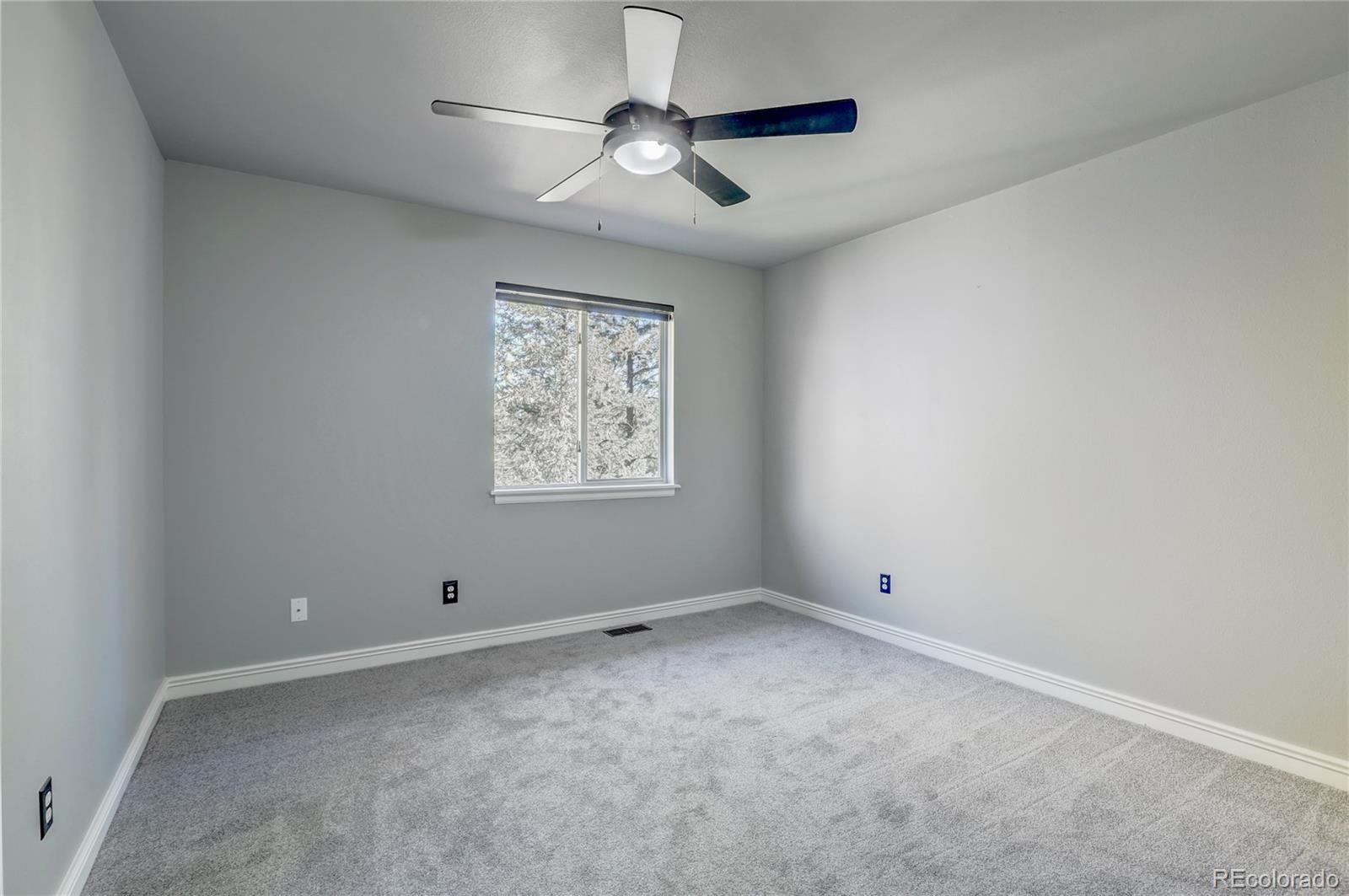 1469 Roland Drive Bailey, CO 80421 - Photo 15 of 39 wooden floor in an empty room with a window