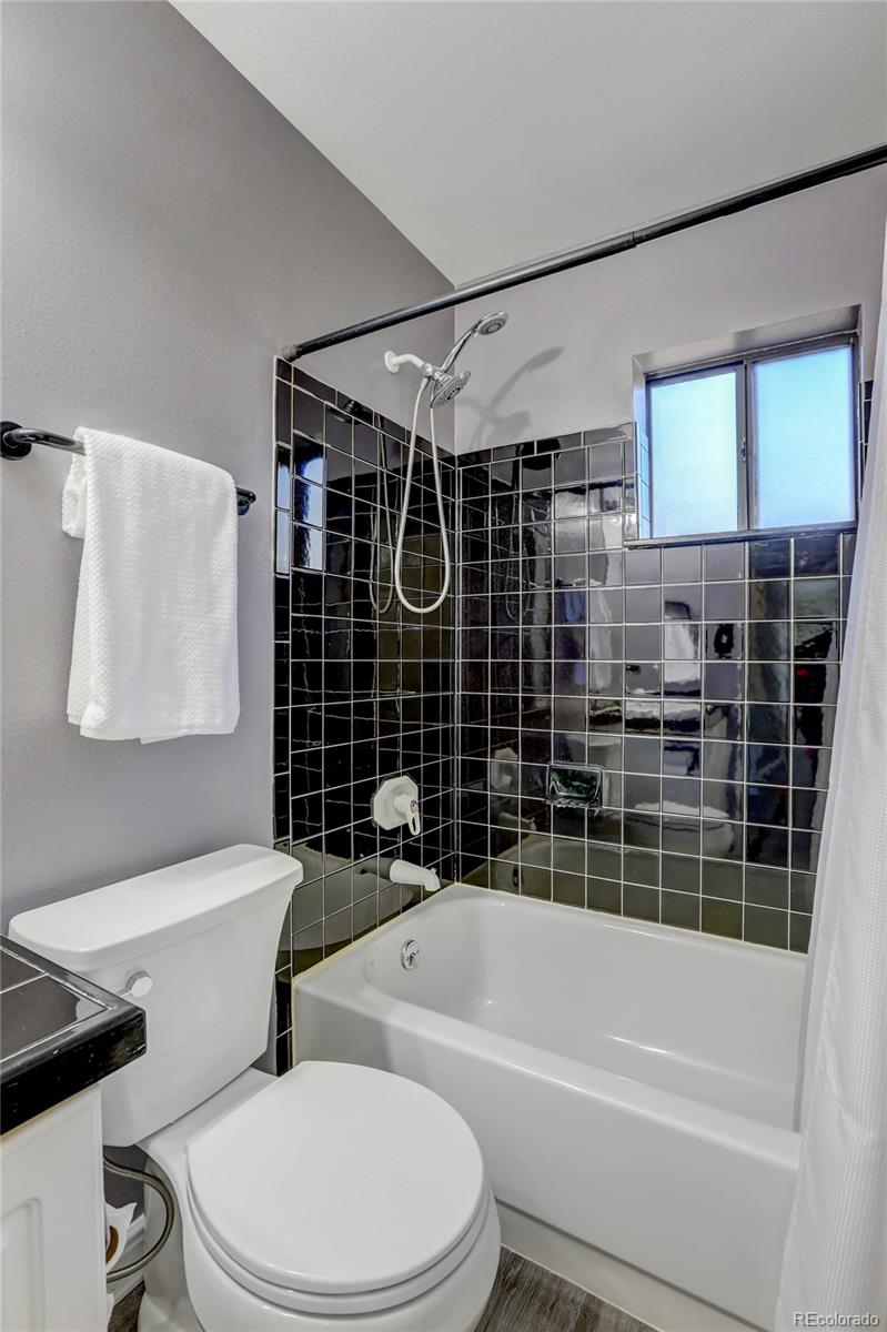 1469 Roland Drive Bailey, CO 80421 - Photo 20 of 39 a bathroom with a toilet and a bathtub