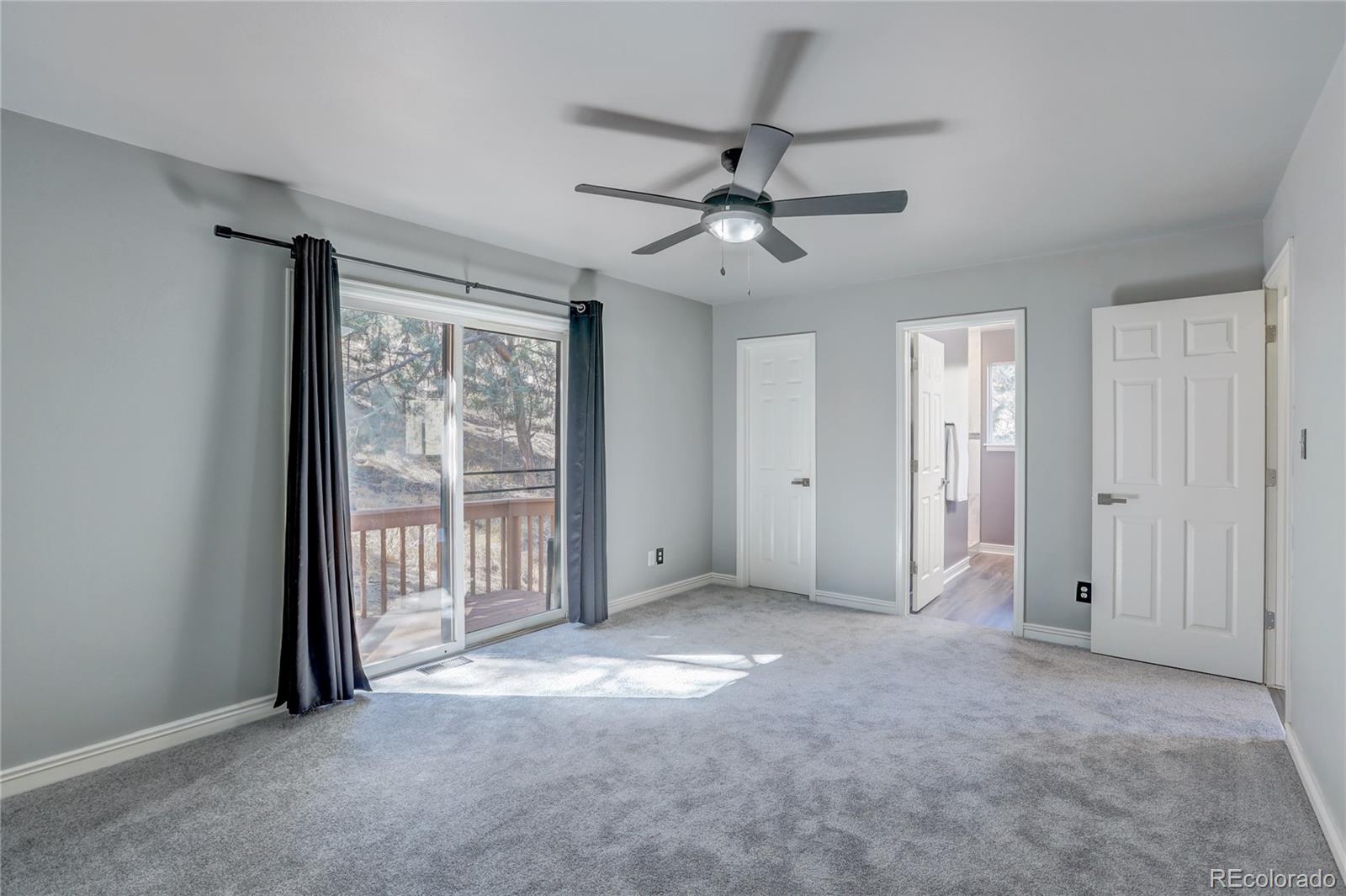 1469 Roland Drive Bailey, CO 80421 - Photo 22 of 39 a view of a livingroom with a ceiling fan & windows