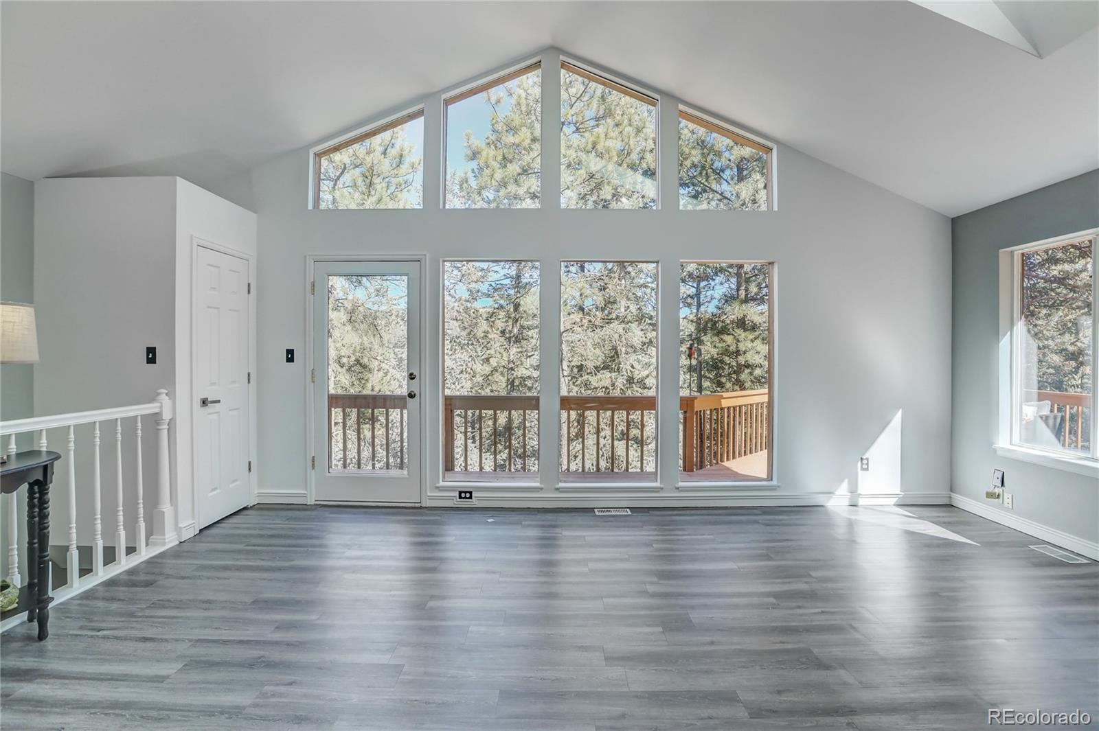 1469 Roland Drive Bailey, CO 80421 - Photo 6 of 39 a view of an empty room with wooden floor and a window
