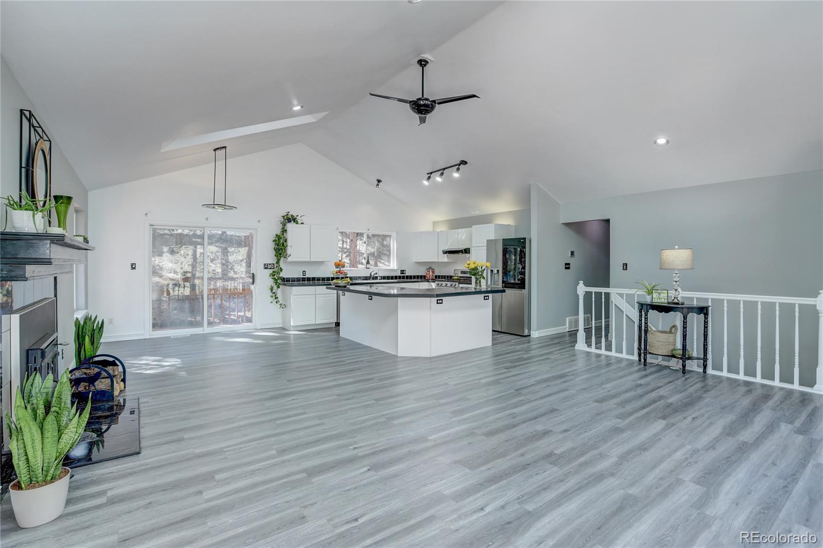 1469 Roland Drive Bailey, CO 80421 - Photo 7 of 39 a view of a kitchen with kitchen island a wooden floor stainless steel appliances and wooden floor