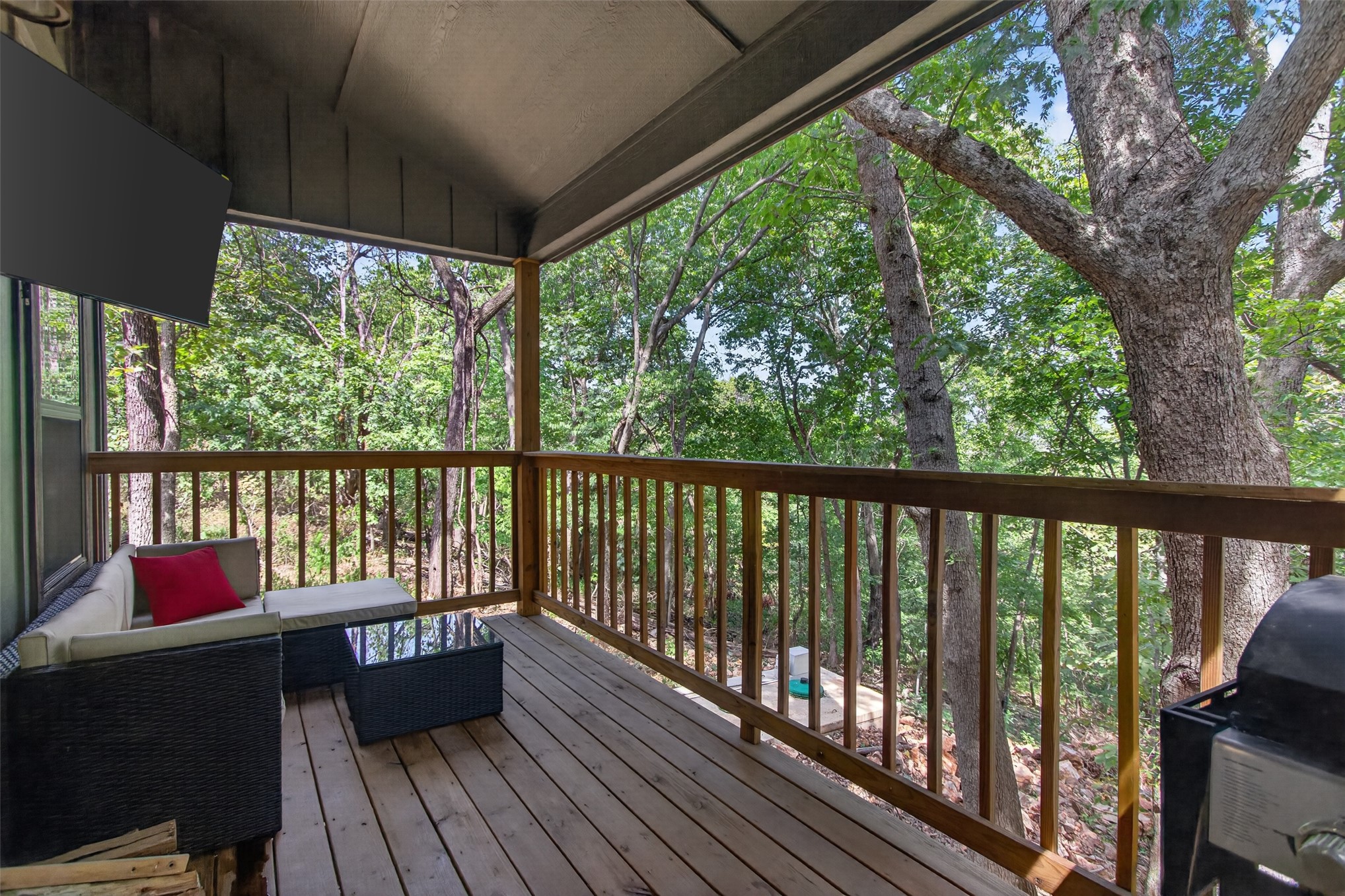13063 East 403 Road Spavinaw, OK 74366 - Photo 17 of 25 Covered outdoor deck with wood flooring and natural wood railings
